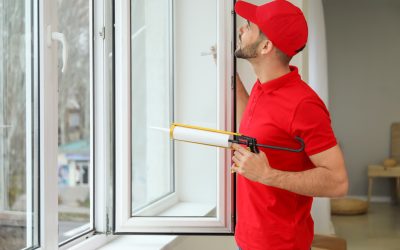 Young worker installing window in flat Young worker installing window in flat